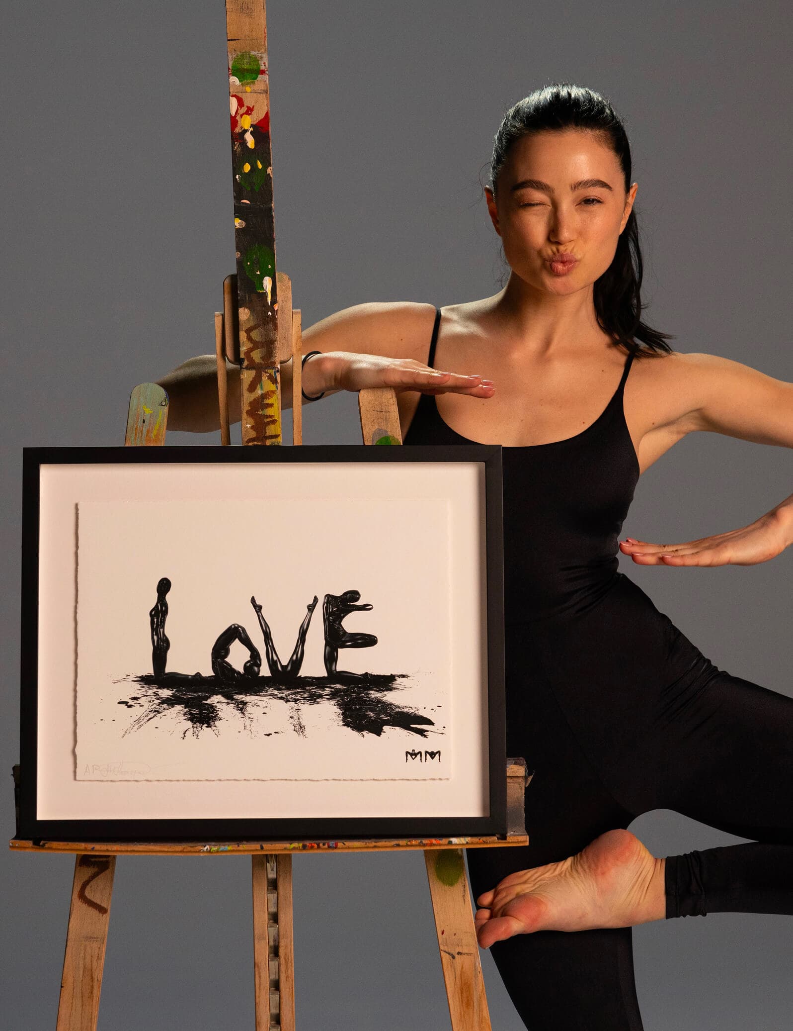 Marina Mazepa posing beside a framed LOVE print
