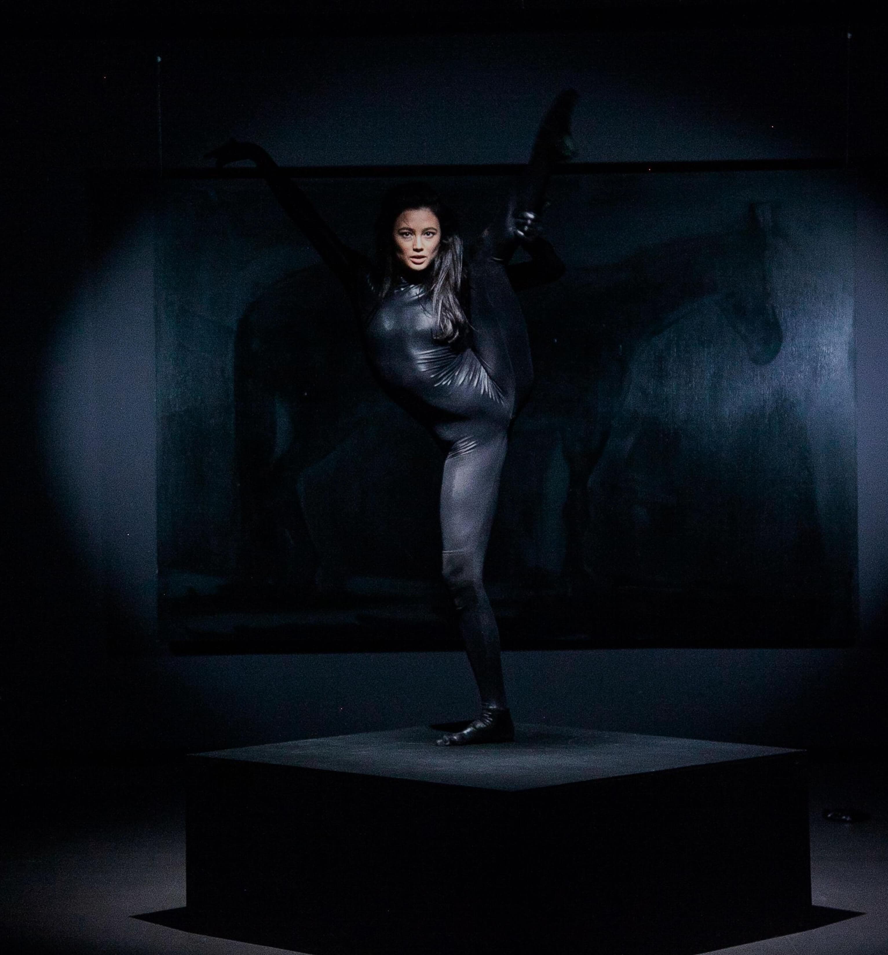 Marina Mazepa holding a standing split on stage