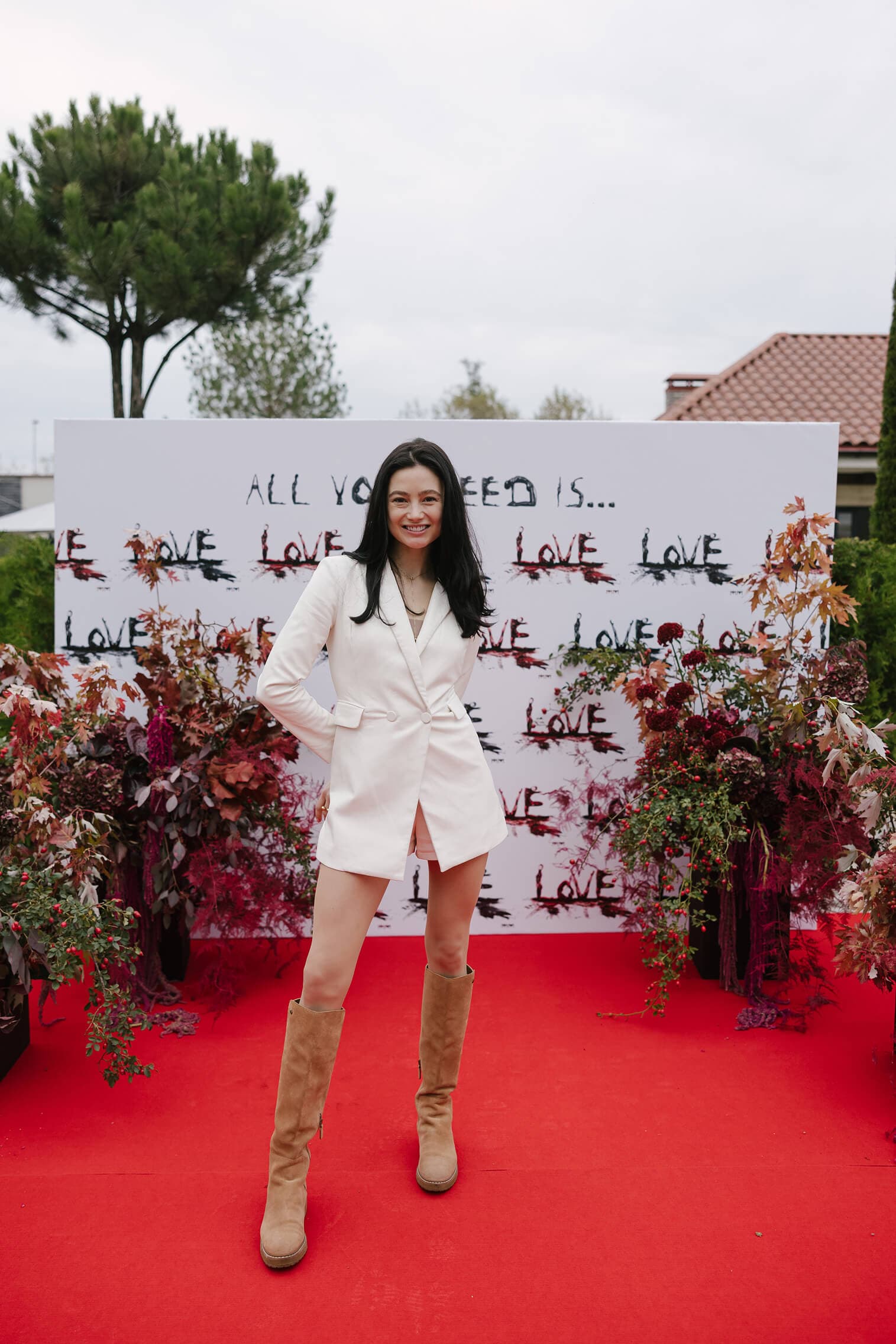 Marina Mazepa in front of an All You Need Is Love wall