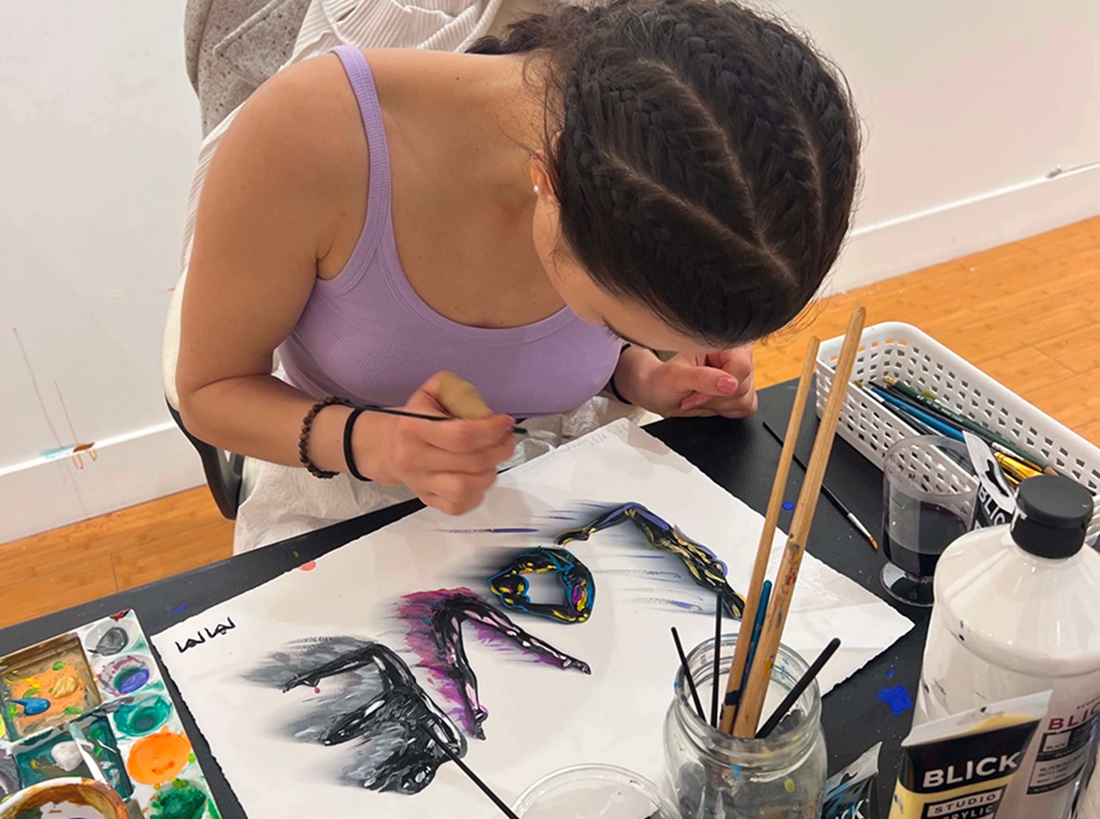 Painting a colorful LOVE letter in the studio